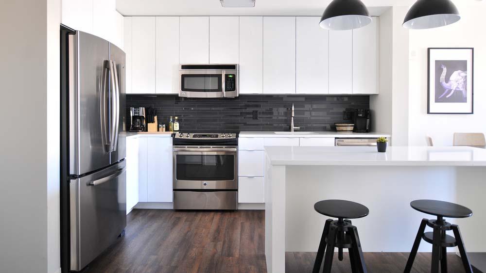 A kitchen with a large french door refrigerator