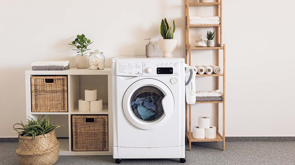 A laundry room with a white washing machine