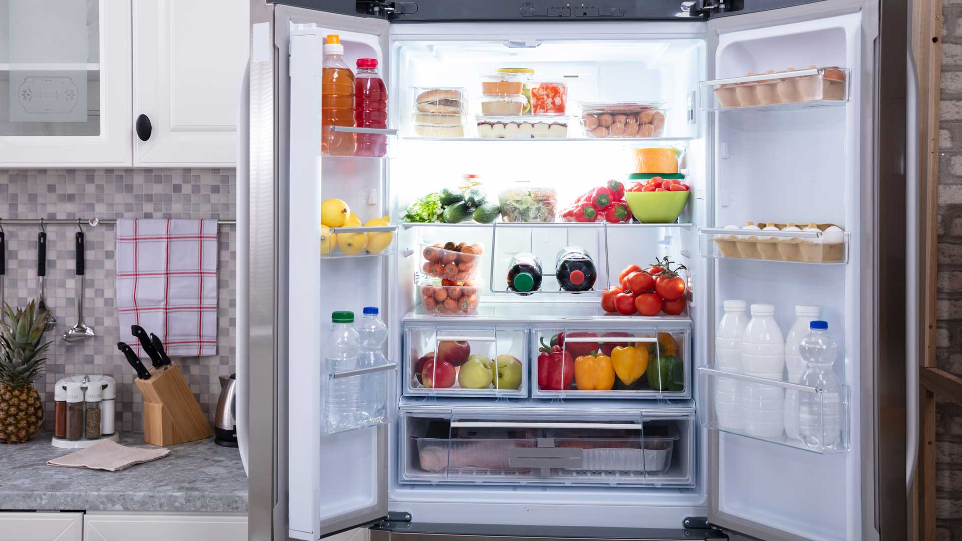Interior shot of fridge, full of fresh fruits and vegetables